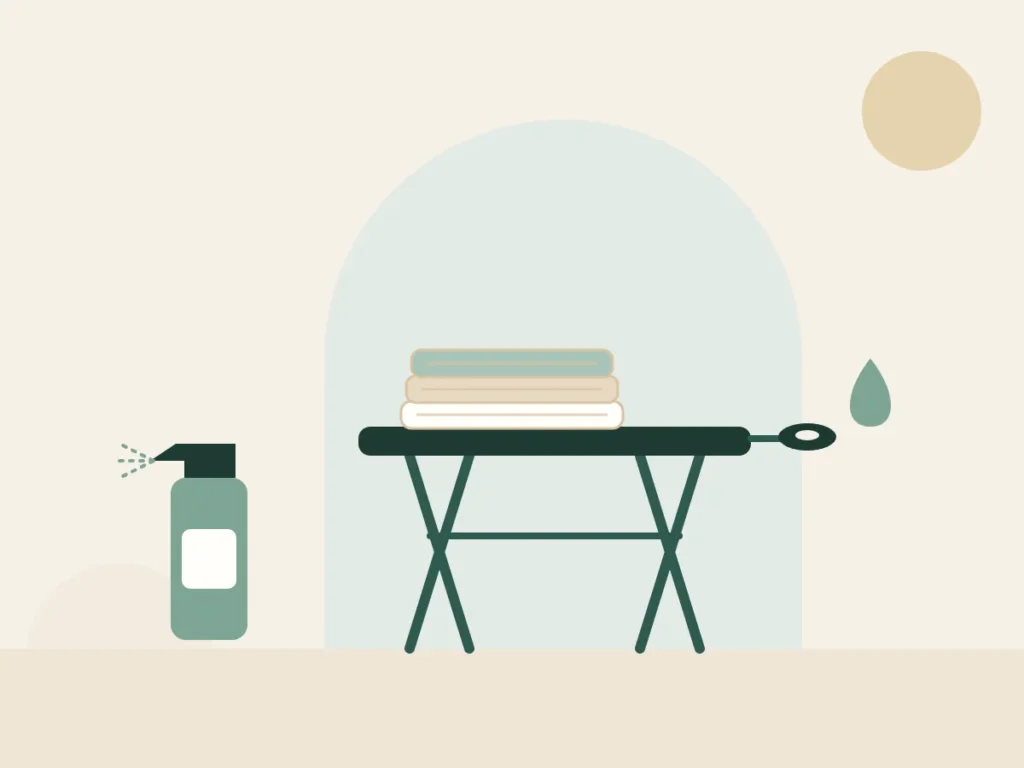 Freshly laundered sheets and a disinfectant spray beside a portable massage table